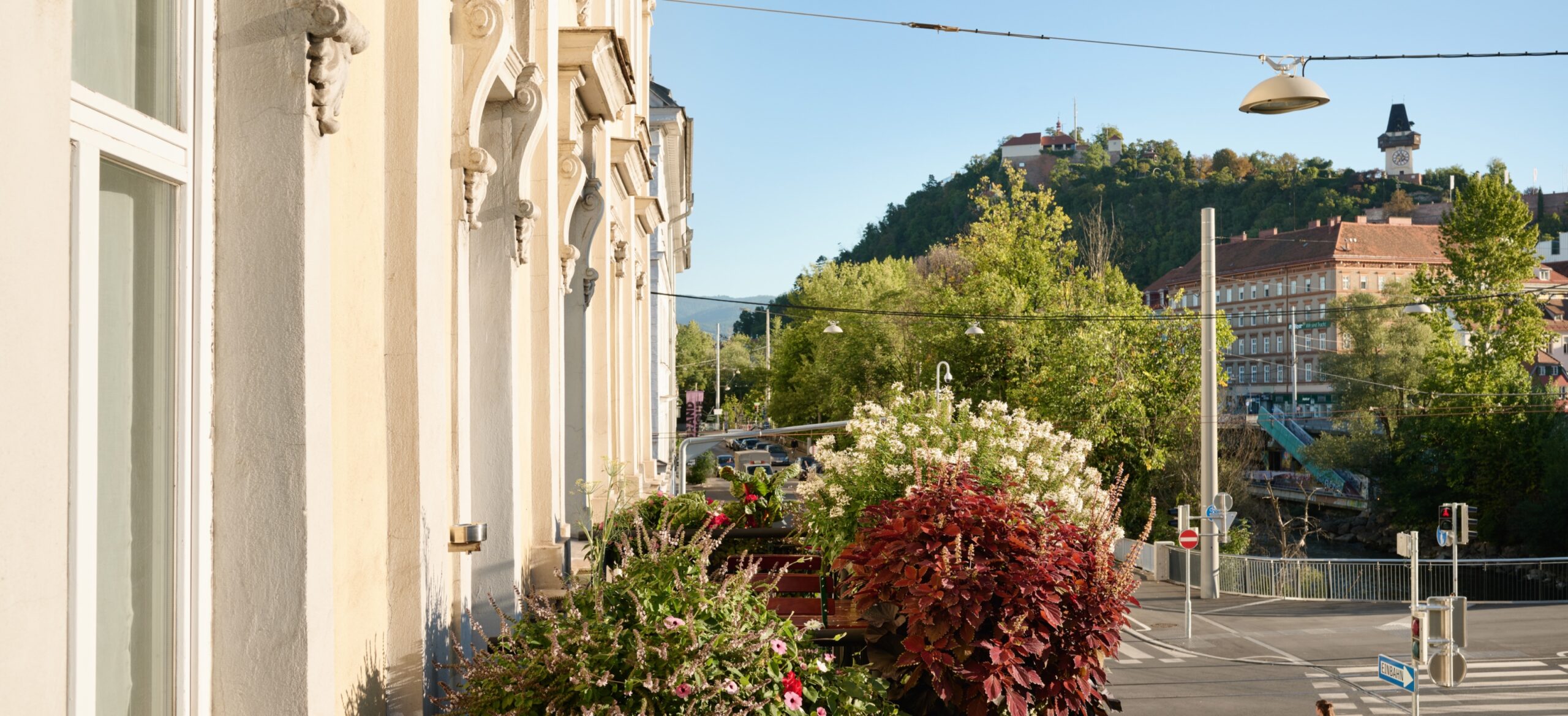 Balcony view of Graz, Austria, overlooking Schlossberg hill and the Graz Clock Tower.